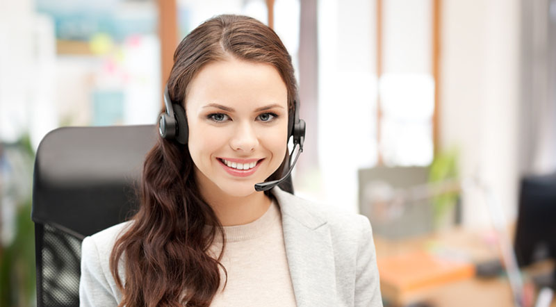 Smiling, female help line operator assisting Cascade Tel's customers